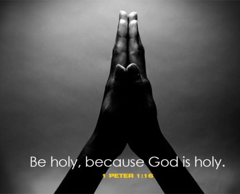 black and white photo of 2 hands praying says be holy because god is holy first peter 1 and 16