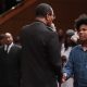 Bishop Blake shakes the hand of young man at altar call west angeles church