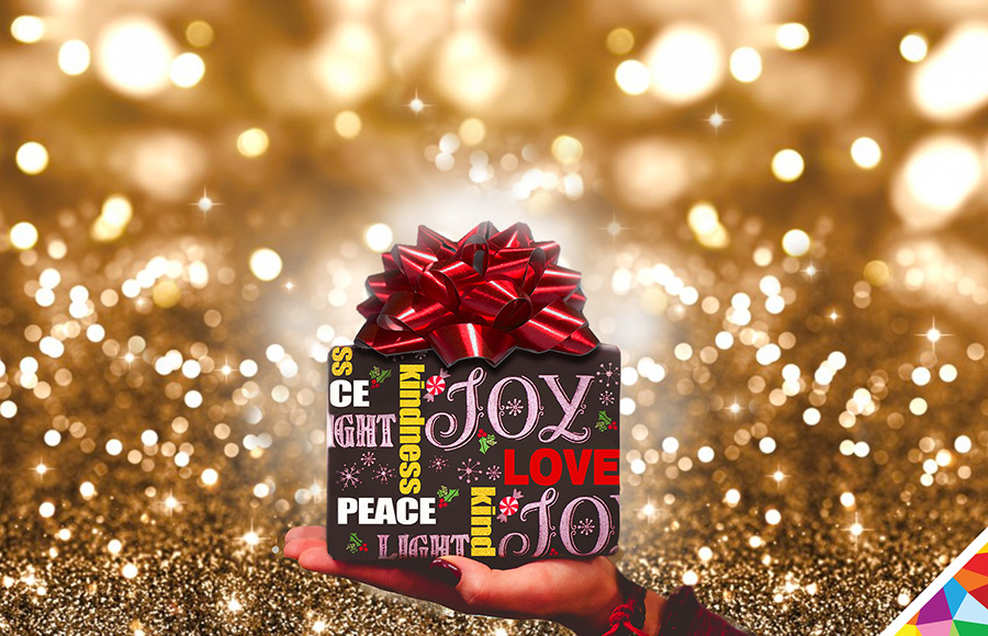 christmas gift wrapped with fruits of the spirit love joy peace kindness gold bokeh background